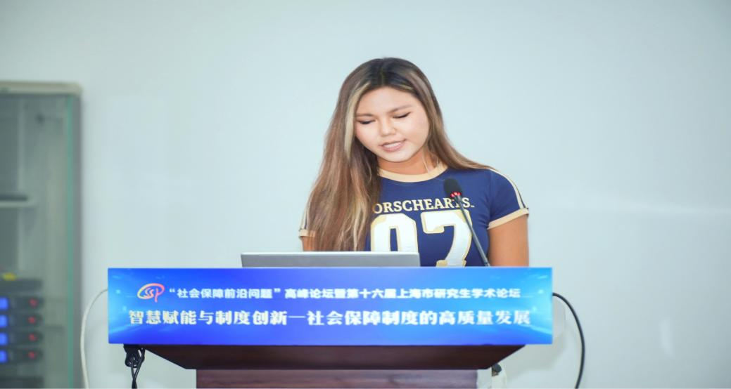 Fig. 4 A student delivering a speech at the High-Level Forum on Cutting-edge Issues in Social Security.png